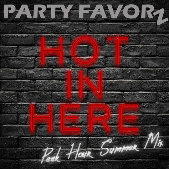 Neon sign hot in here against black brick wall